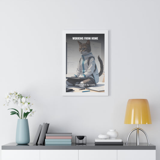 Working From Home, Managed By Cats - A framed wall art print showing a cat wearing business attire sitting at a desk, depicting a humorous take on remote work supervision, displayed in a modern home office setting with white walls and minimalist decor.