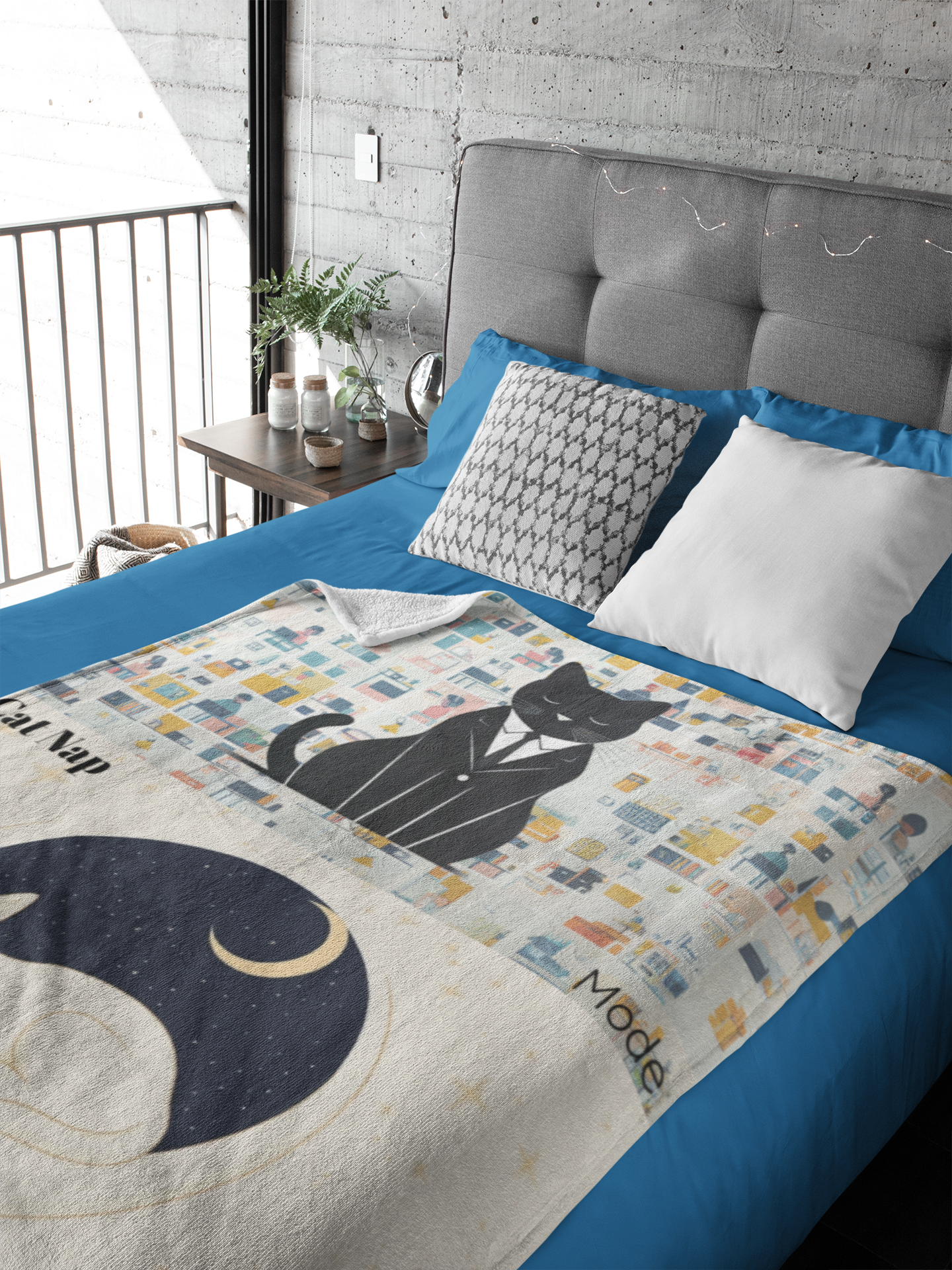 Luxurious Cat Moon Sherpa Fleece Blanket displayed on blue bedding, featuring a whimsical black cat design in business attire against a cityscape pattern with a crescent moon motif. The plush white blanket creates an elegant contrast with modern bedroom decor including grey upholstered headboard and concrete wall.