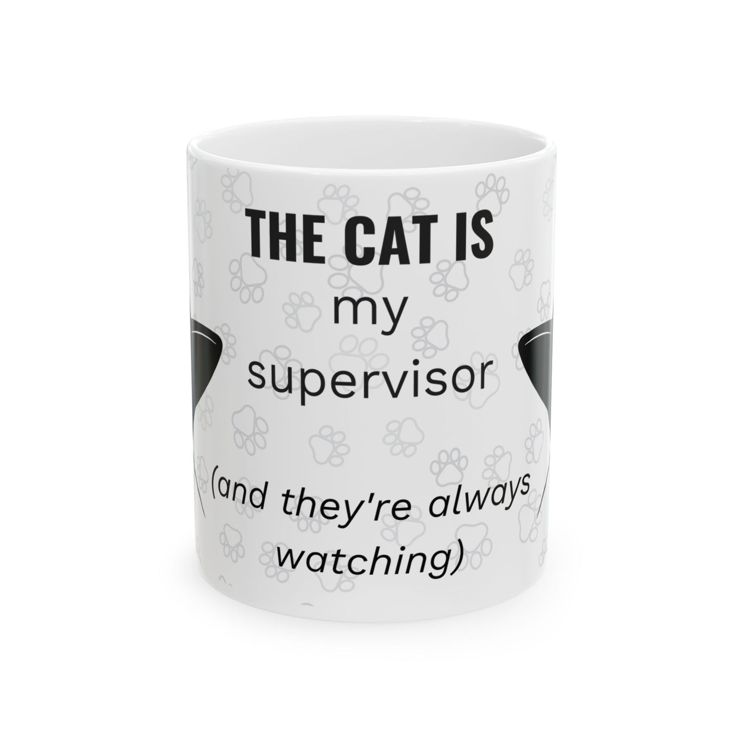 White ceramic mug with "The Cat Is My Supervisor" text design featuring cat ear silhouettes and paw print patterns. Text reads "and they're always watching" below the main message, perfect for cat-loving remote workers.