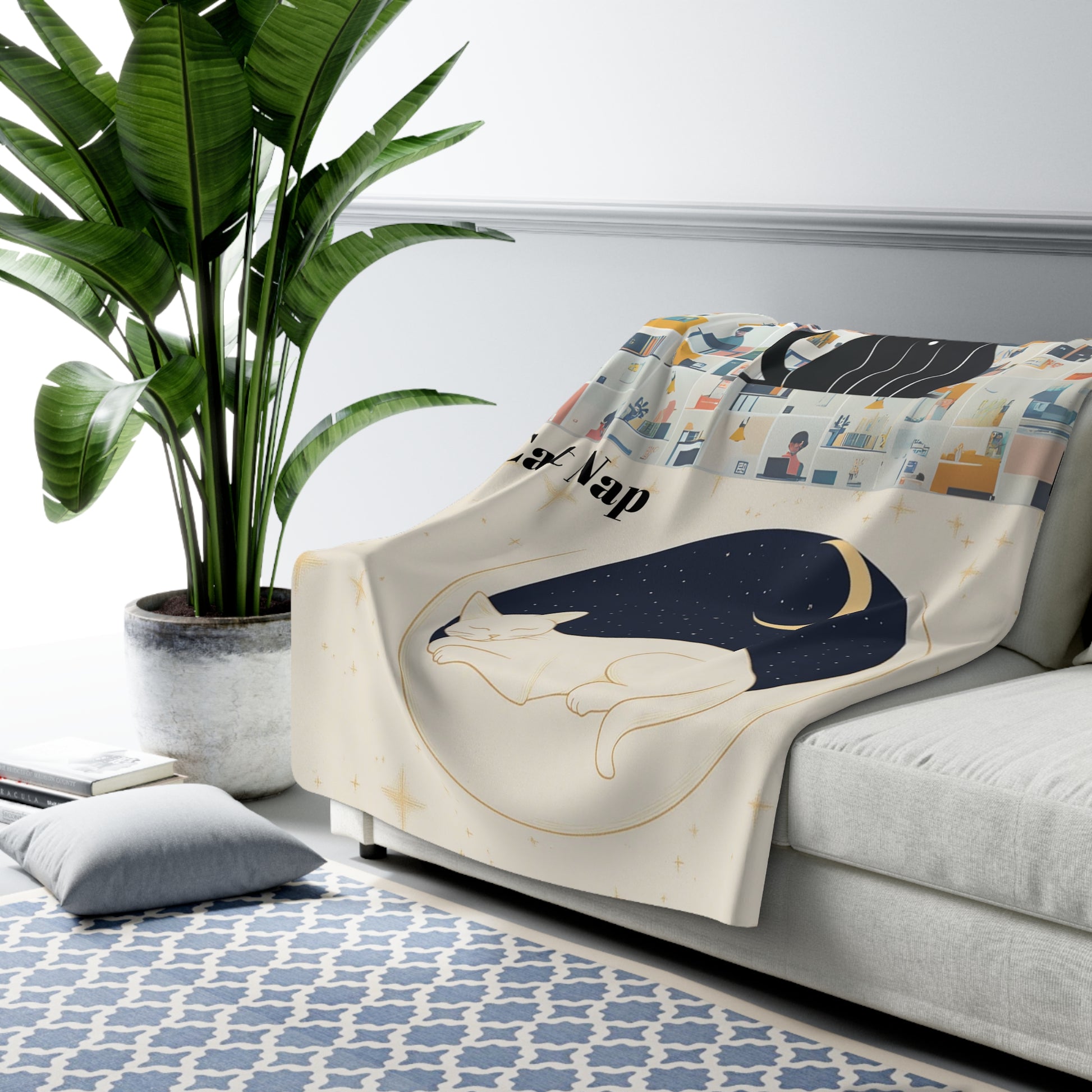 Luxurious Cat Moon Sherpa Fleece Blanket displayed on a gray couch, featuring a minimalist design of a sleeping cat silhouette against a crescent moon in dark blue and cream colors, with a potted palm plant visible in the background against a white wall and blue geometric patterned rug.